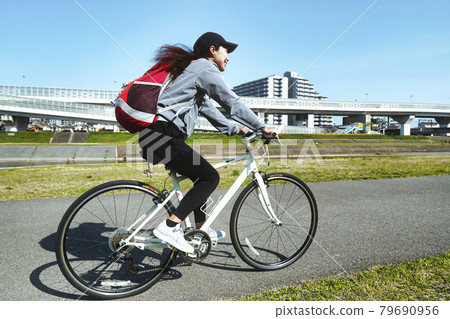 Woman riding a road bike 79690956