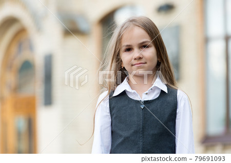 Always in style. Little child wear uniform outdoors. Back to school style.  79691093