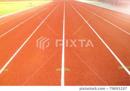 Red running track in stadium. 79693287