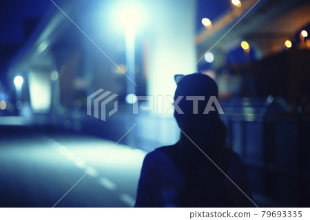 Woman walking on the night road 79693335