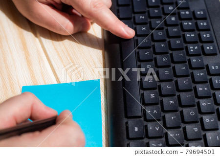 Hands Pressing Computer Keyboard Keys While Writing With Pencil In Notepad. Palms Typing Notebook Keypad And Writing Pencil Over Paper. 79694501