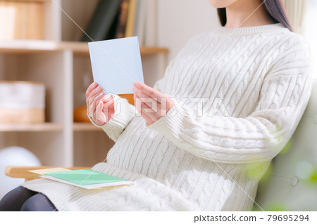 Pregnant woman checking mail letter notice notification Pregnant woman checking mail letter notice notification 79695294