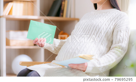 Pregnant woman checking mail Letter Notice Announcement 16:9 Pregnant woman checking mail Letter Notice Announcement 16:9 79695295