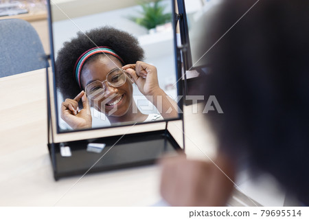 Mirror with face woman African American wear spectacles. 79695514