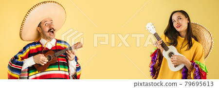 Collage of portraits of young people, man and woman in mexican clothes with ukulele isolated over yellow studio background. Collage of portraits of young people, man and woman in mexican clothes with ukulele isolated over yellow studio background. 79695613