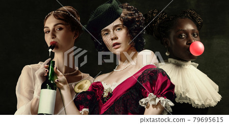 Medieval women as a historical persons in vintage clothing on dark background. Concept of comparison of eras, modernity and renaissance, baroque style. Medieval women as a historical persons in vintage clothing on dark background. Concept of comparison of eras, modernity and renaissance, baroque style. 79695615