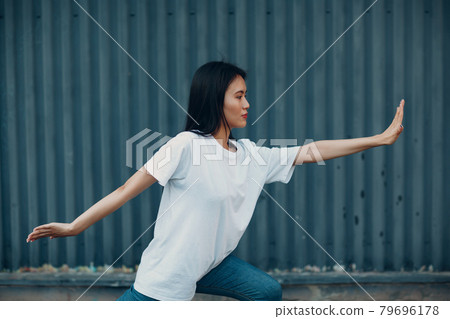 Asian young woman doing qigong exercise summer outdoor 79696178