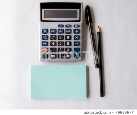 Blank Opened Spiral Notebook With A Calculator And A Pen Placed Over A Table. Empty Lined Notepad And Pencil On Top Of A Desk With A Calculation Device. 79696677