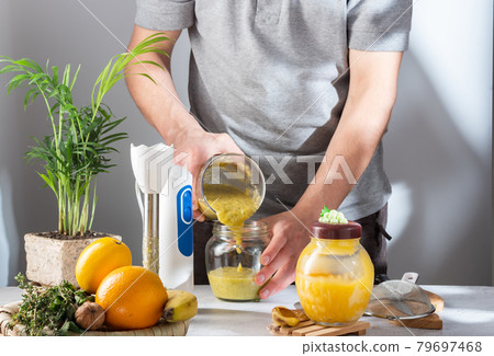 Pour the jam into a glass jar. Pour from jar to jar. The cook pours jam into jars. 79697468