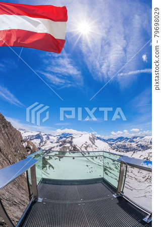 Kitzsteinhorn glacier view against flag of Austria in Kaprun- Zell am see area, Salzburg region, Austrian Alps, Austria 79698029