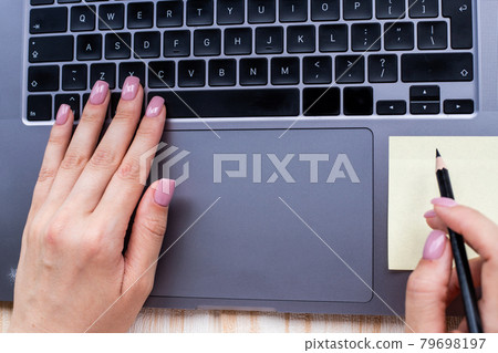 Hands Pressing Computer Keyboard Keys While Writing With Pencil In Notepad. Palms Typing Notebook Keypad And Writing Pencil Over Paper. 79698197