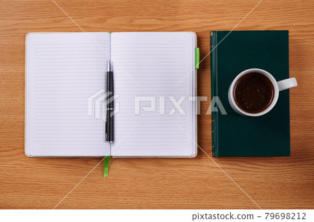 Plain Blank Notebooks And A Pen Beside A Cup Of Coffee Placed Book Table. Simple Empty Notepads With A Ballpen And Mug Over Dictionary Desk. Plain Blank Notebooks And A Pen Beside A Cup Of Coffee Placed Book Table. Simple Empty Notepads With A Ballpen And Mug Over Dictionary Desk. 79698212
