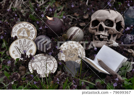 Grunge still life wil skull, crystal, burning candle, book and magic ritual objects outside. Esoteric, gothic and occult background, Halloween mystic and wicca concept.  79699367