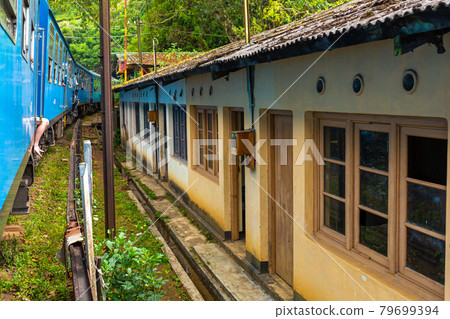 Traveling around the island of Sri Lanka by train. Residential buildings are close to the railroad. Terrible living conditions Traveling around the island of Sri Lanka by train. Residential buildings are close to the railroad. Terrible living conditions 79699394