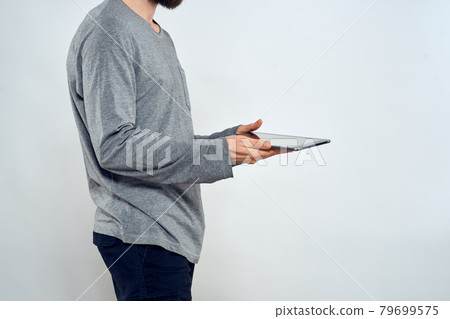 Man with tablet in hands technology lifestyle internet communication work light background cropped view 79699575