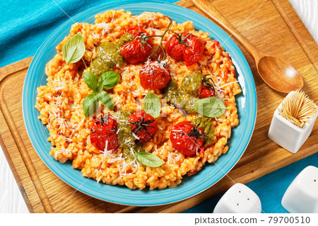creamy tomato risotto with pesto, top view 79700510