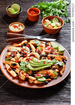 Mexican chicken salad on a plate, top view 79700517