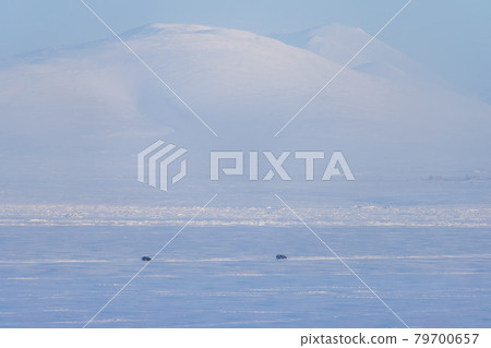 Cars are driving on snow and ice 79700657