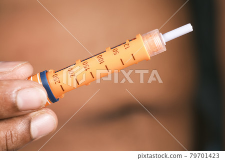 young man hand using insulin pen close up young man hand using insulin pen close up 79701423