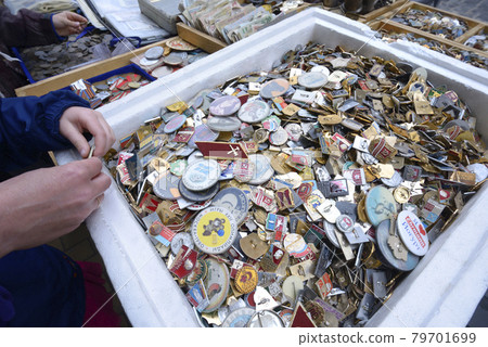 Pile of an old Soviet USSR pins medals badges placed on a tray for sale. Flea market 79701699