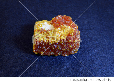Clouse-up of yellow orpiment from the eastern Ukraine, on a blue background 79701810