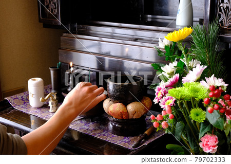 Stock photo of hands offering incense at a Buddhist altar 79702333