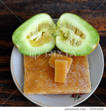 Melon fruits cut in half ready to eat with sugar bar 79703099