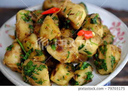 plate of vegan Vietnamese food, breadfruit fried and cook dried with sauce and chili 79703175