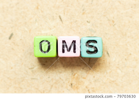 Color alphabet letter block in word OMS (Abbreviation of Order management system or Operations management system) on wood background 79703630