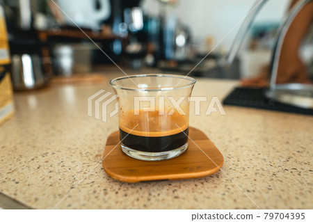 Ecfresso coffee from a press machine into a mug Ecfresso coffee from a press machine into a mug 79704395