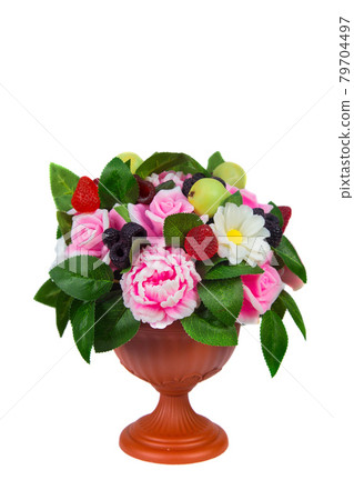 A vase with handmade soap in the shape of flowers raspberries blackberries and pears on a white background A vase with handmade soap in the shape of flowers raspberries blackberries and pears on a white background 79704497