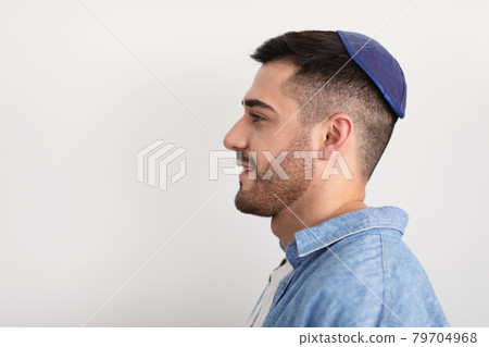 Closeup profile portrait of smiling jewish man in yarmulke Closeup profile portrait of smiling jewish man in yarmulke 79704968