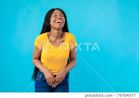 Joyful African American Female Laughing Out Loud, Blue Background Joyful African American Female Laughing Out Loud, Blue Background 79704977
