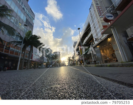 Pedestrian street with palm trees and blue sky with white clouds Pedestrian street with palm trees and blue sky with white clouds 79705253