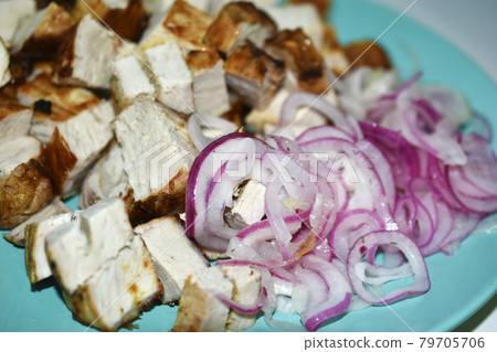 Fried pieces of delicious pork meat with pickled onions Fried pieces of delicious pork meat with pickled onions 79705706