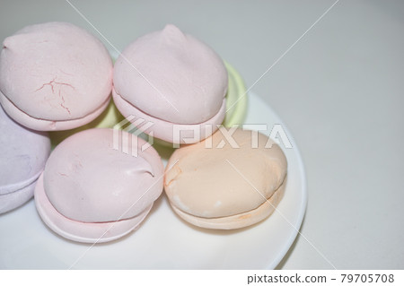 Colorful delicious marshmallows on a white plate Colorful delicious marshmallows on a white plate 79705708