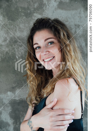 portrait of a beautiful woman in a black dress on a gray background portrait of a beautiful woman in a black dress on a gray background 79706090