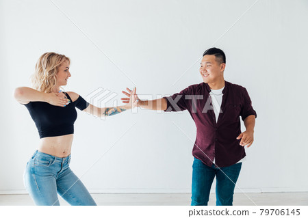a man and a woman dance bachata music in a white room a man and a woman dance bachata music in a white room 79706145