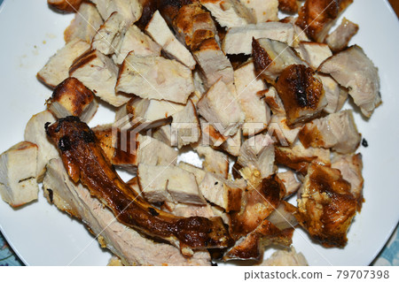 Chunks of roast pork on a white plate 79707398