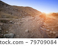 rocky road in the foothills at sunset. Uzbekistan 79709084
