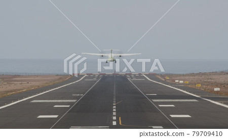 Aircraft taking off from runway by the ocean Aircraft taking off from runway by the ocean 79709410