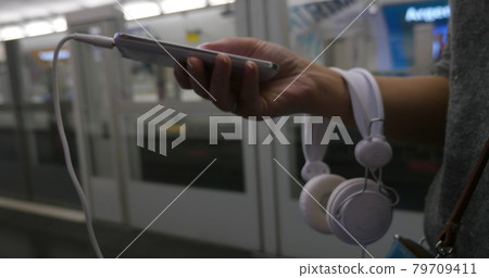 Woman using cellphone in subway 79709411