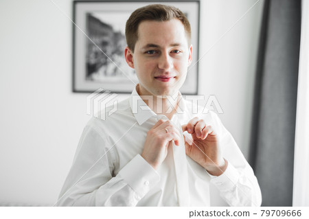 Beautiful man, groom posing and preparing for wedding Beautiful man, groom posing and preparing for wedding 79709666