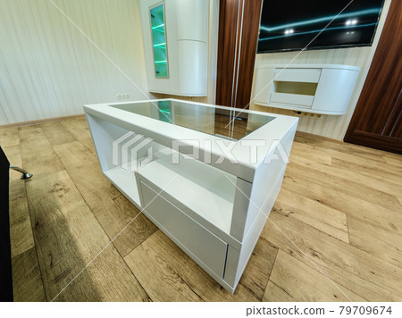 Modern furniture in a minimalist design executed in white color in a home interior. Modern furniture in a minimalist design executed in white color in a home interior. 79709674