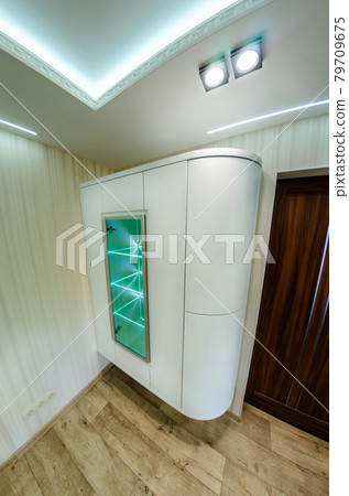 Modern furniture in a minimalist design executed in white color in a home interior. Modern furniture in a minimalist design executed in white color in a home interior. 79709675