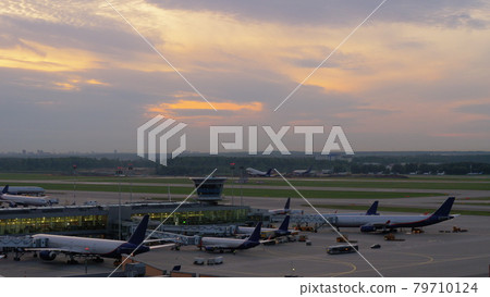 Airport view with airplanes boarding and taking off 79710124