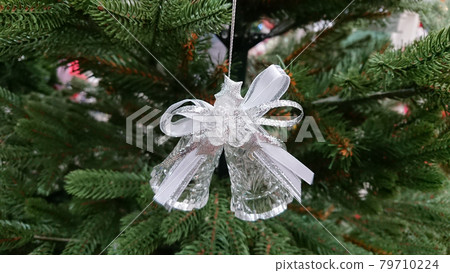 The decoration stands on the branches of the Christmas tree 79710224