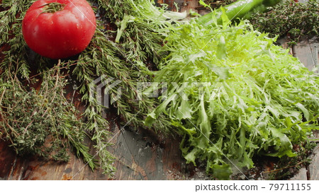 Fresh herbs, salad and vegetables on the table Fresh herbs, salad and vegetables on the table 79711155