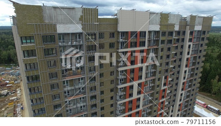 A huge apartment building with a forest behind A huge apartment building with a forest behind 79711156
