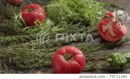 Vegetarian set on the table. Fresh herbs, salad and tomatoes Vegetarian set on the table. Fresh herbs, salad and tomatoes 79711160